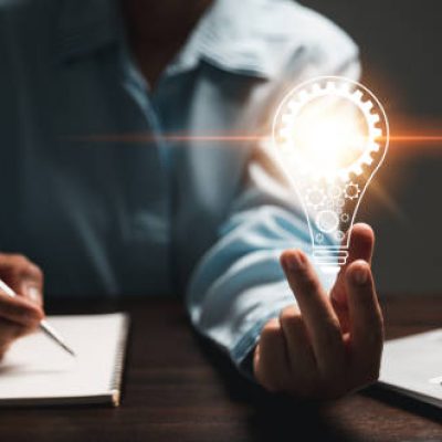 Hand of woman with light bulb and there is gear icon and using laptop computer. Idea of ​​inspiration from online technology. Innovation idea concept. Concept of brainstorming inspiration creatively.